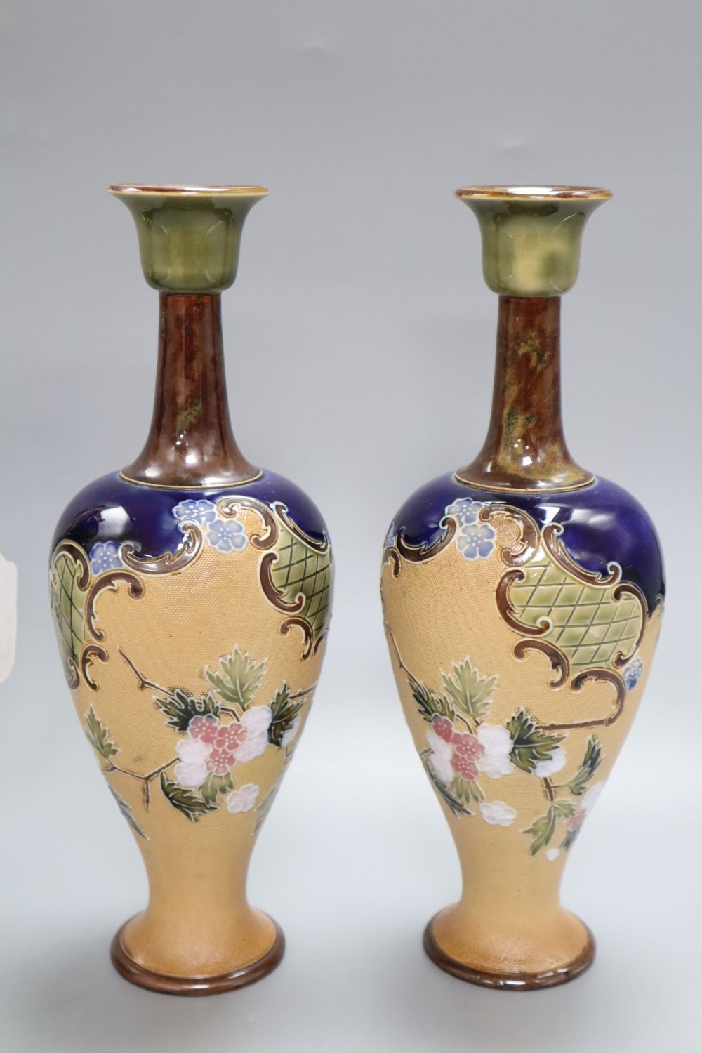 A pair of Doulton Slaters patent stoneware vases, Continental figures and a Vienna style urn and cover, tallest 28cm